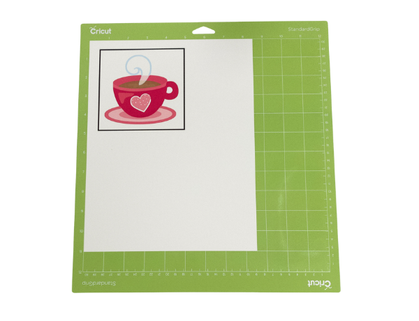 printed pink coffee cup on white paper on a cricut mat